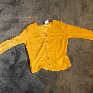 A burnt yellow shirt wit buttons